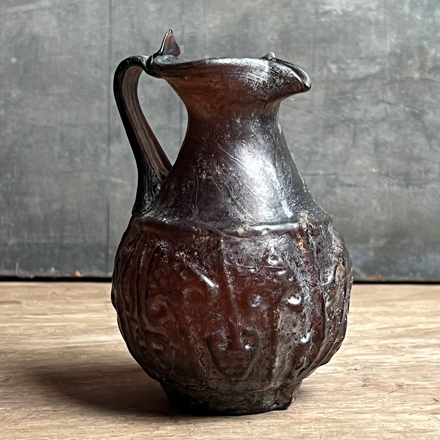 A Roman Aubergine Glass Trefoil-Lipped Jug c. 1st Century A.D.