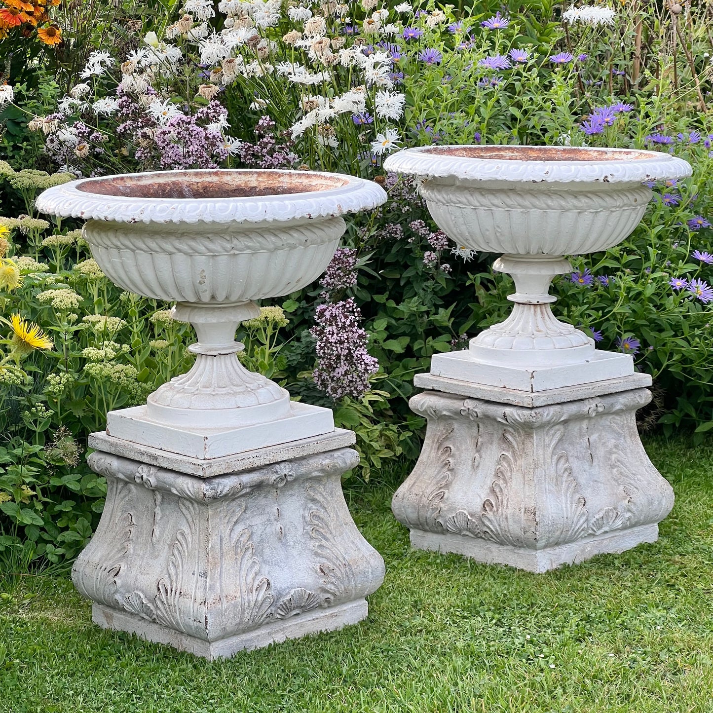 Pair of English Victorian Cast Iron Garden Urns on Ornamented Bases