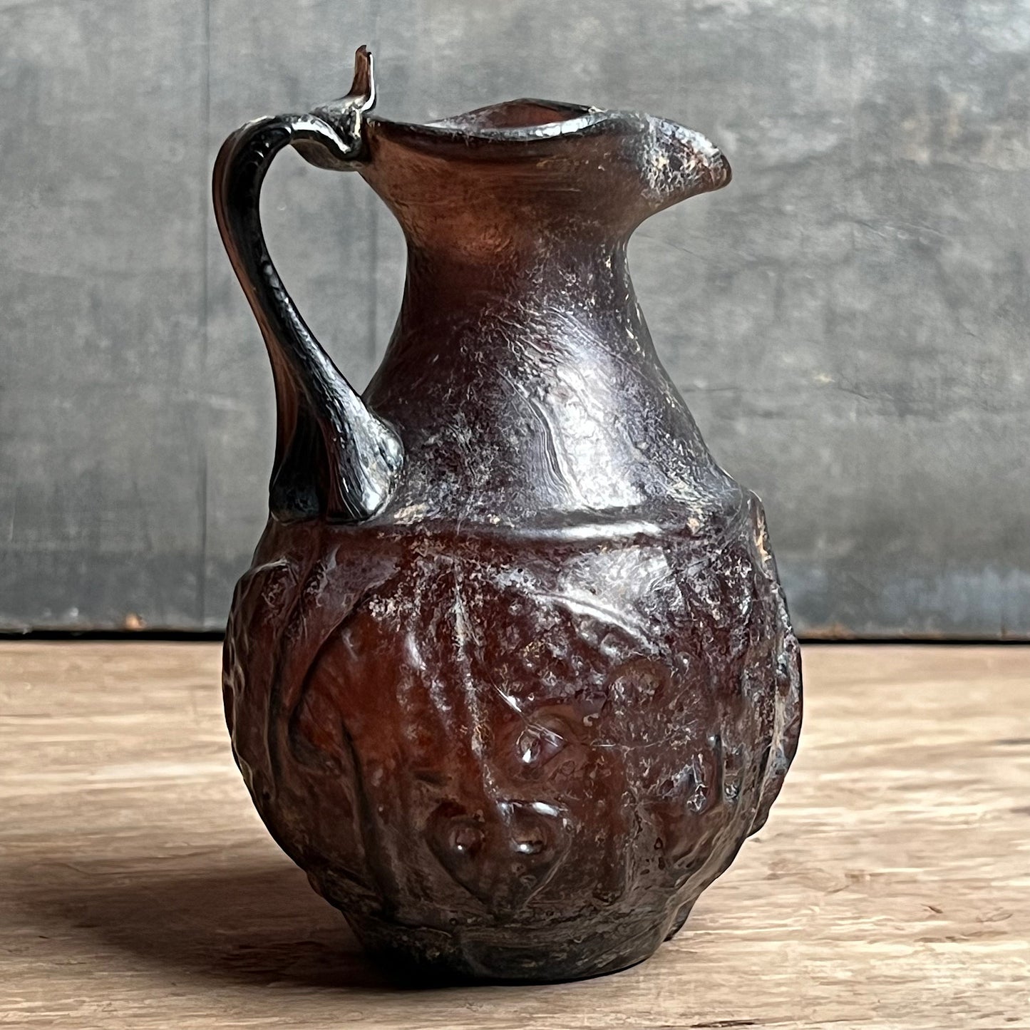 A Roman Aubergine Glass Trefoil-Lipped Jug c. 1st Century A.D.