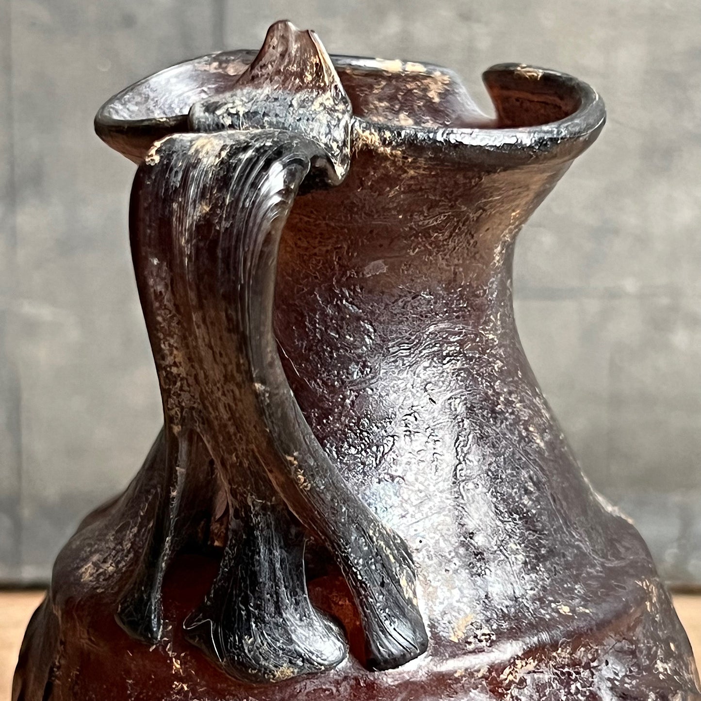 A Roman Aubergine Glass Trefoil-Lipped Jug c. 1st Century A.D.