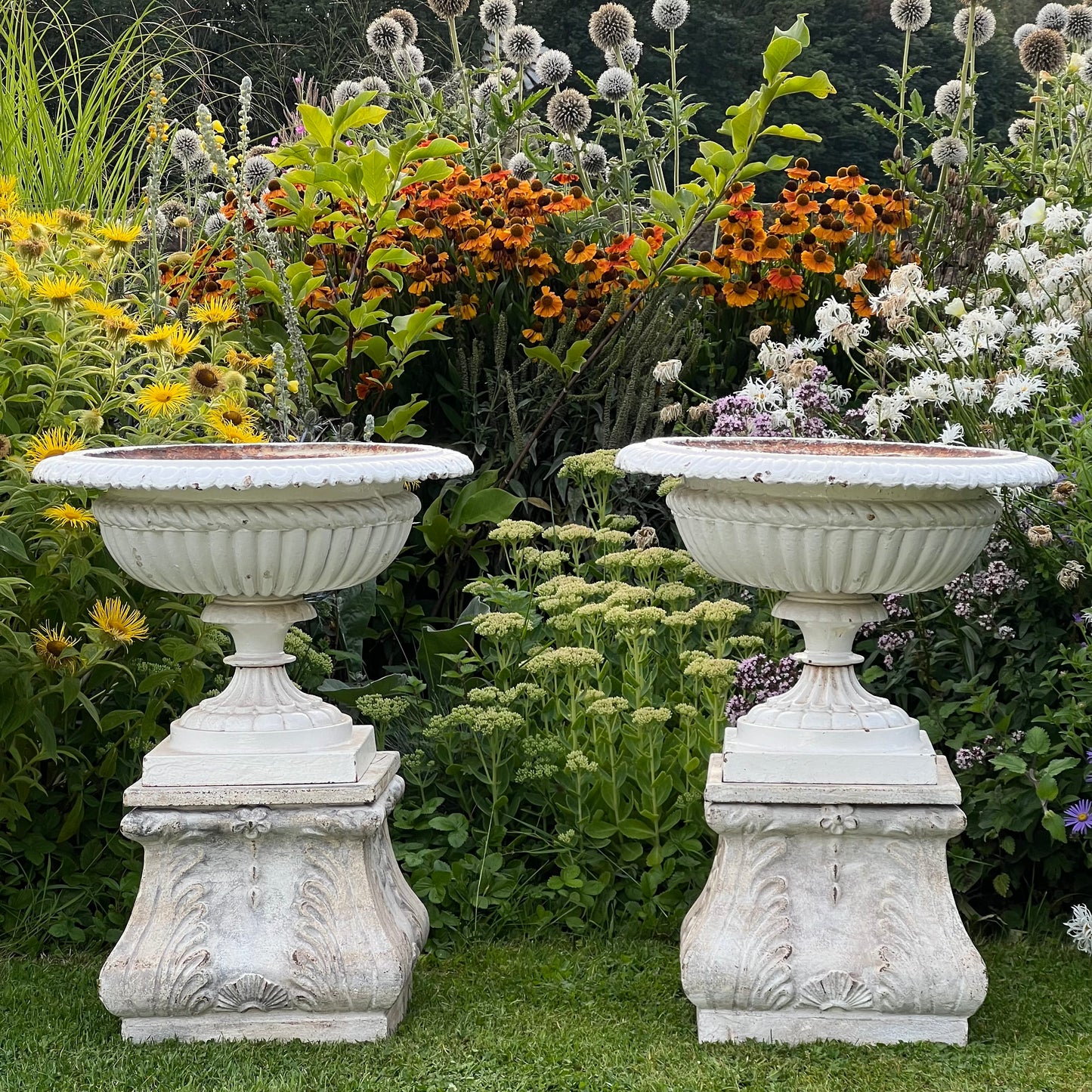 Pair of English Victorian Cast Iron Garden Urns on Ornamented Bases