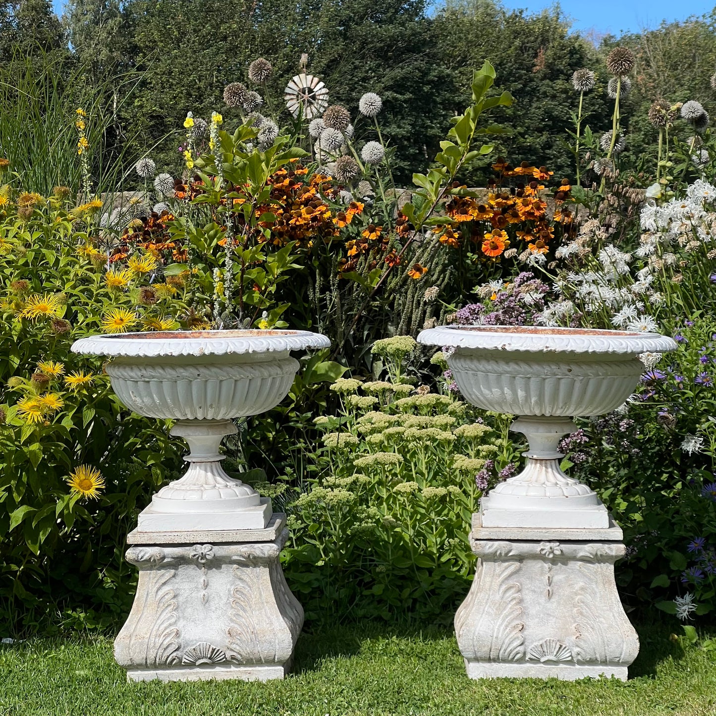 Pair of English Victorian Cast Iron Garden Urns on Ornamented Bases