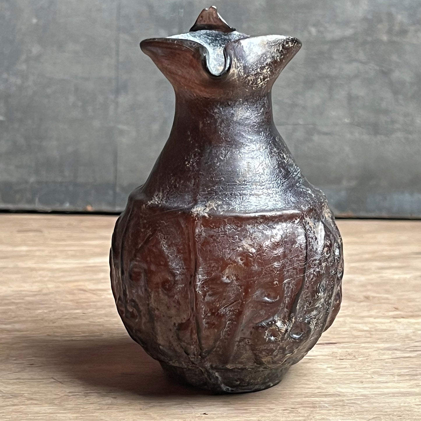 A Roman Aubergine Glass Trefoil-Lipped Jug c. 1st Century A.D.