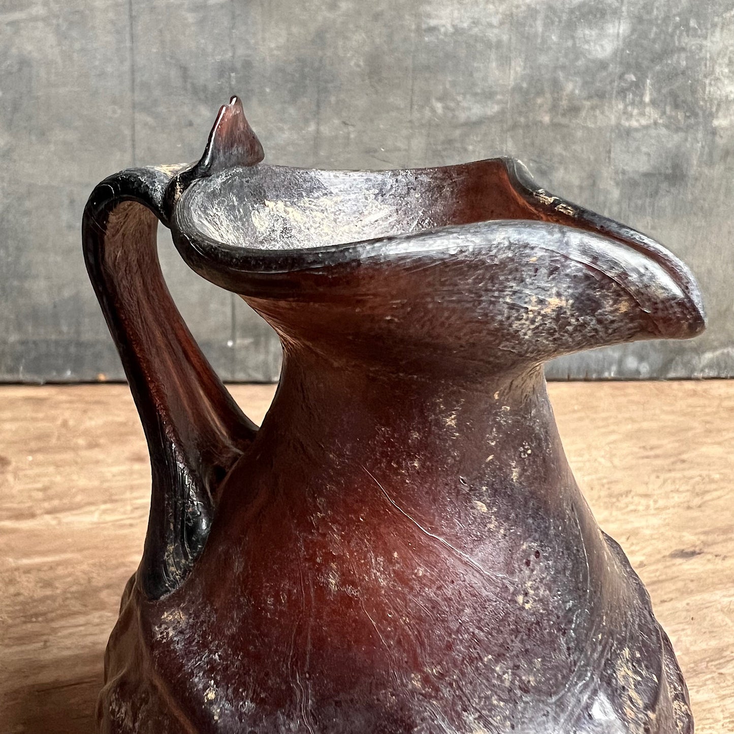 A Roman Aubergine Glass Trefoil-Lipped Jug c. 1st Century A.D.