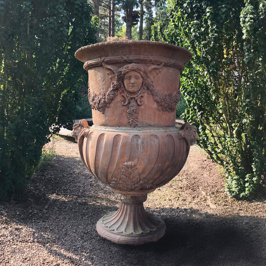 Monolithic Terracotta Rams Head and Winged Maiden Urn
