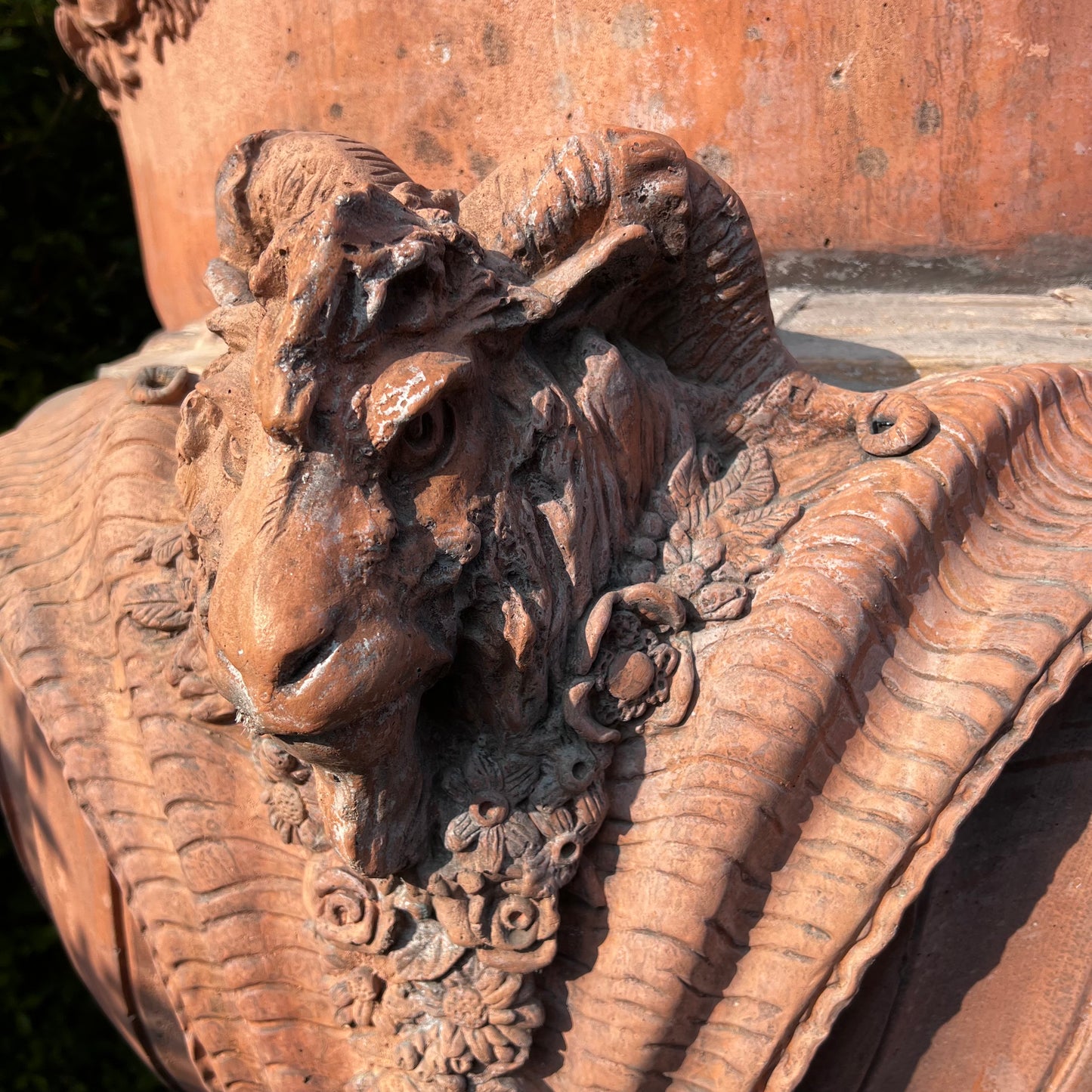 Monolithic Terracotta Rams Head and Winged Maiden Urn