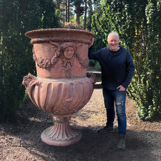 Monolithic Terracotta Rams Head and Winged Maiden Urn