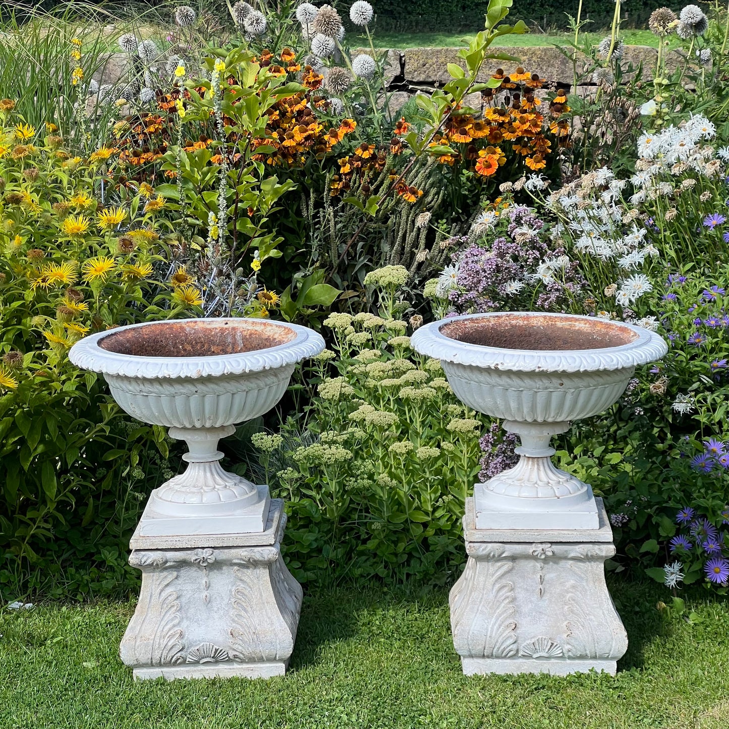 Pair of English Victorian Cast Iron Garden Urns on Ornamented Bases