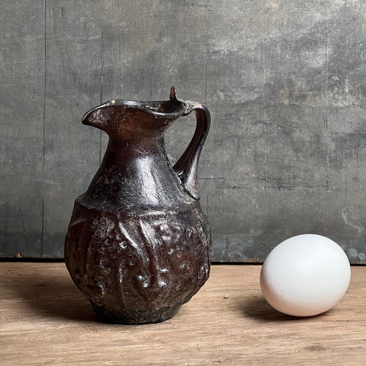 A Roman Aubergine Glass Trefoil-Lipped Jug c. 1st Century A.D.