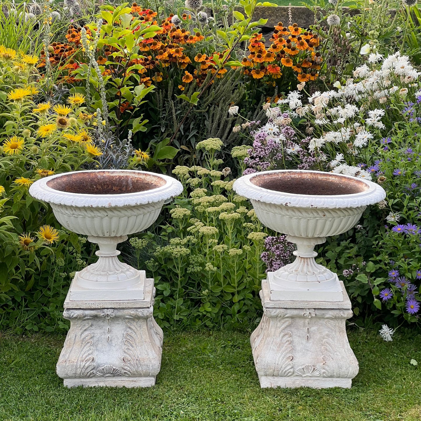 Pair of English Victorian Cast Iron Garden Urns on Ornamented Bases