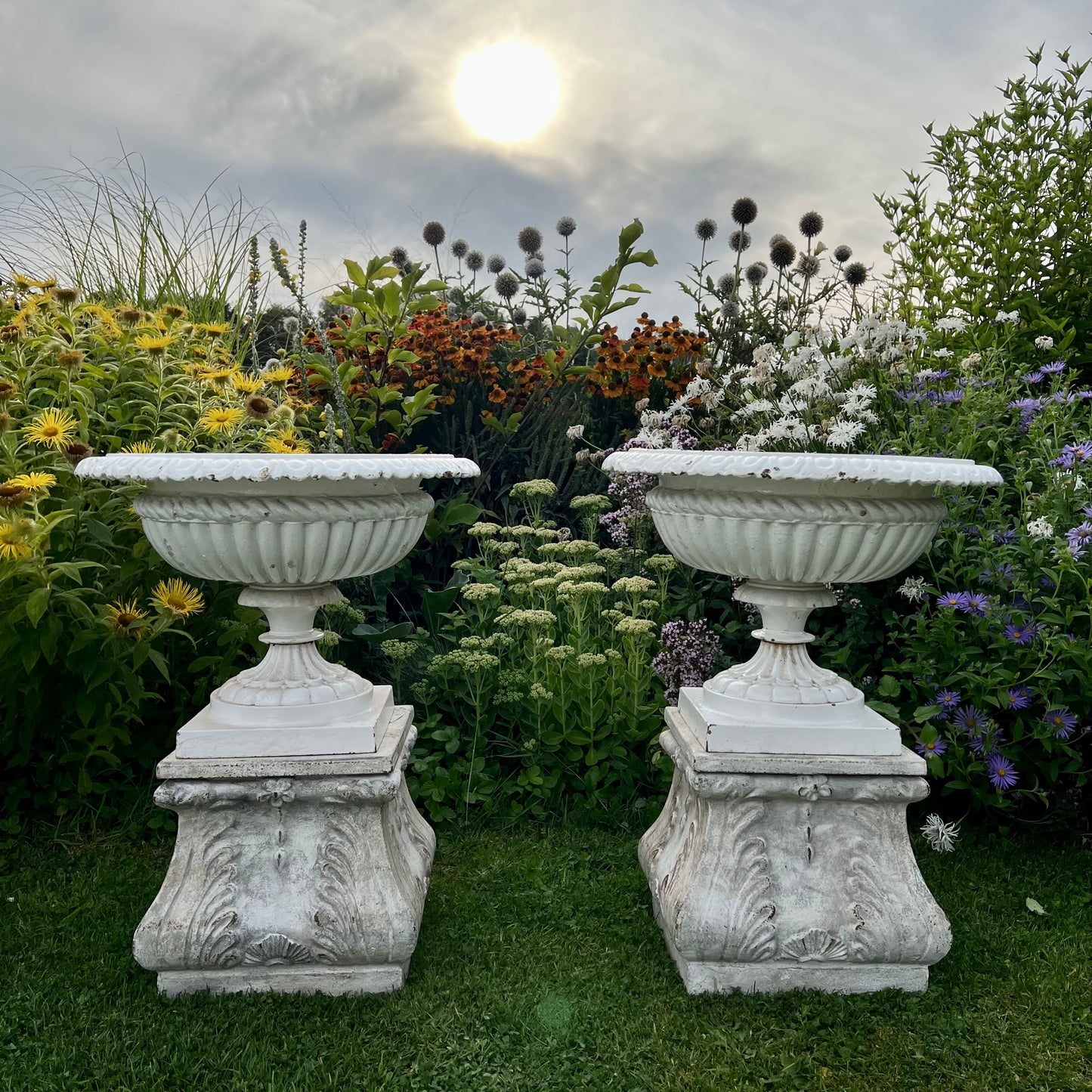 Pair of English Victorian Cast Iron Garden Urns on Ornamented Bases