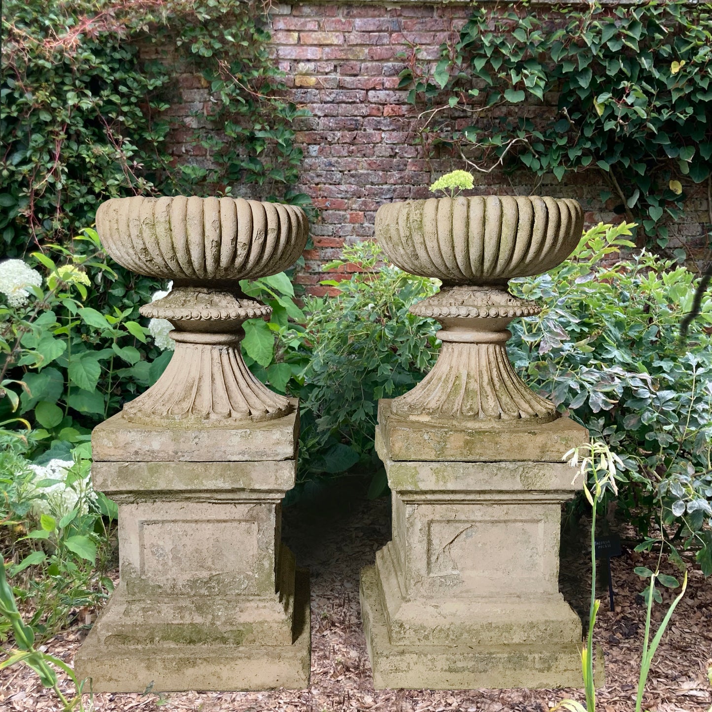 A Pair of Buff Terracotta Urns with Plinths c.1860