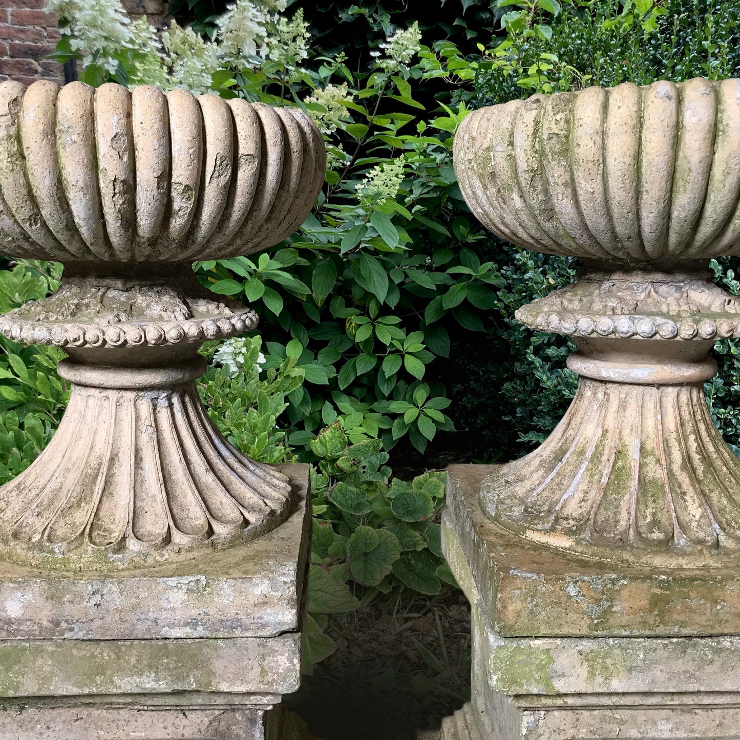 A Pair of Buff Terracotta Urns with Plinths c.1860