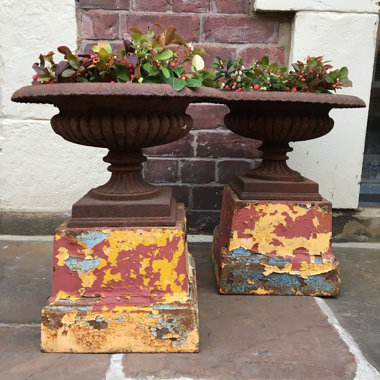 Pair of Cast Urns on Coloured Pedestals