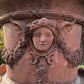 Monolithic Terracotta Rams Head and Winged Maiden Urn
